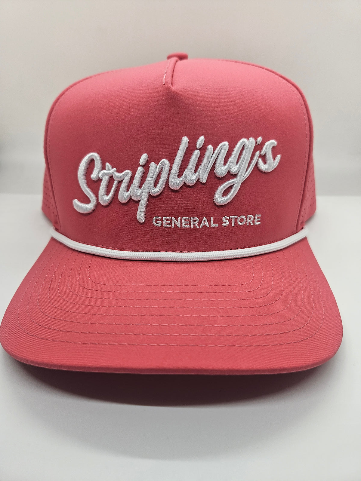 Stripling's coral pink rope hat with raised white script and a white rope