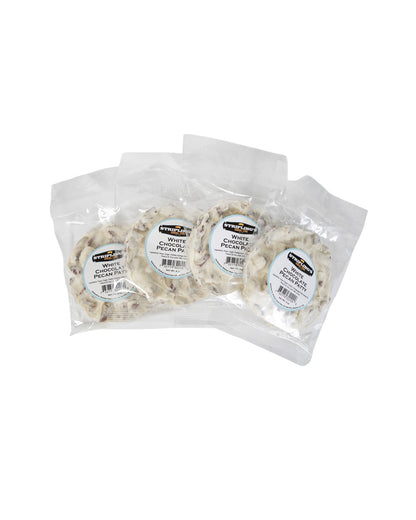 Four Stripling's white chocolate pecan patties in clear bags, fanned out