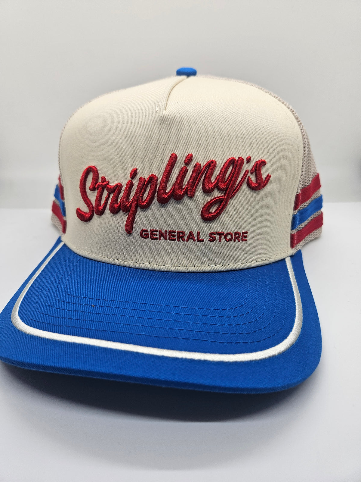 Side view of the Stripling's red, white and blue rope hat showing the striped mesh and white rope